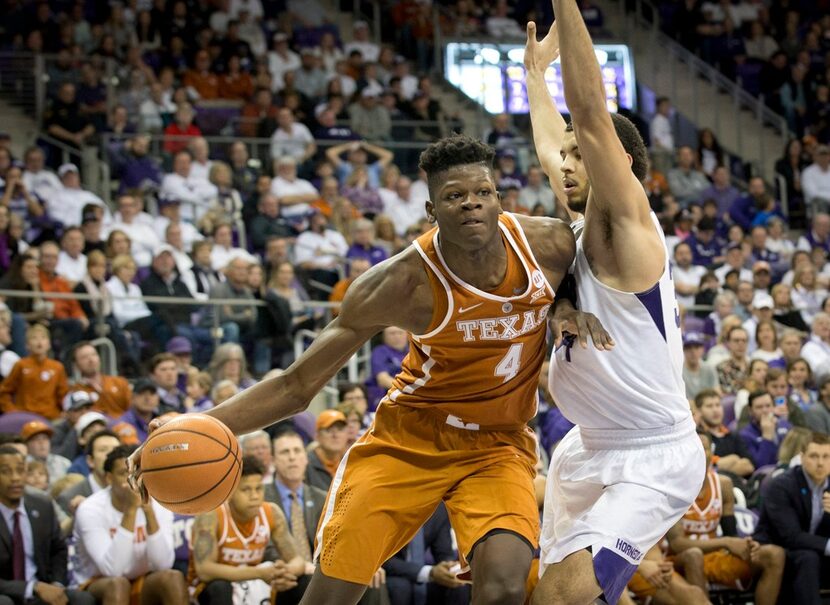 Texas's Mohamed Bamba (4) drives against Texas Christian's Kenrich Williams in the second...