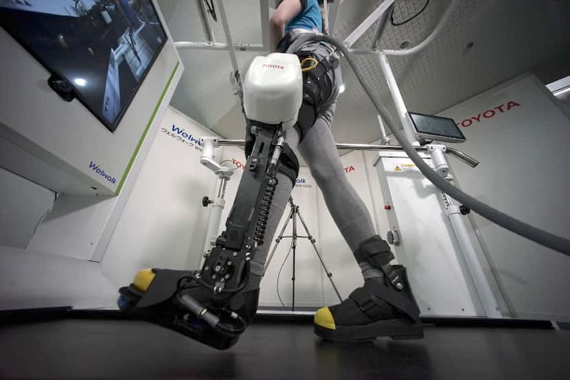 A model demonstrates the Welwalk WW-1000, a wearable robotic leg brace designed to help...