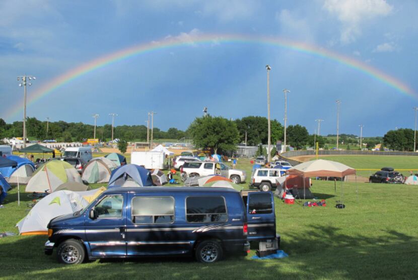 Riders set up campsites beneath a rainbow in Harlan, Iowa (they overnight more than triple...
