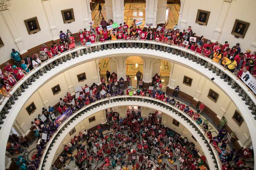 Hundreds of protesters line the balconies of the state Capitol rotunda in Austin on Monday,...