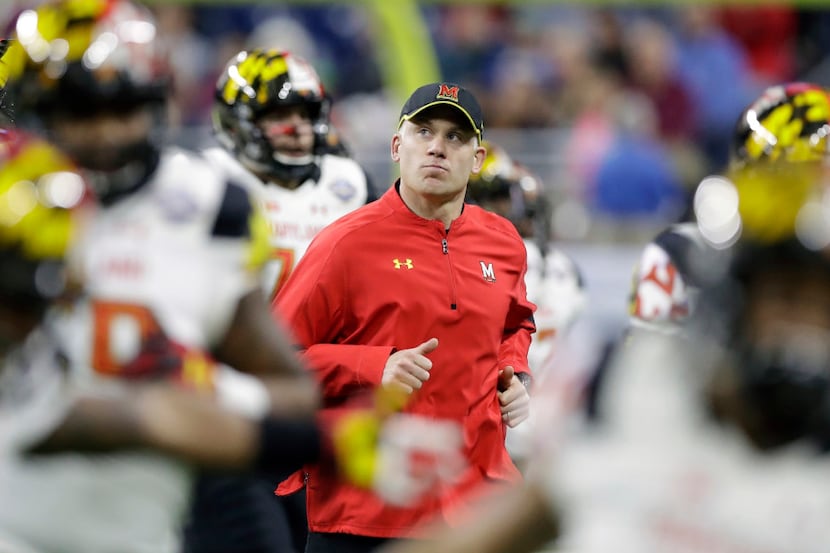 FILE - In this Monday, Dec. 26, 2016 file photo, Maryland head coach DJ Durkin runs onto the...