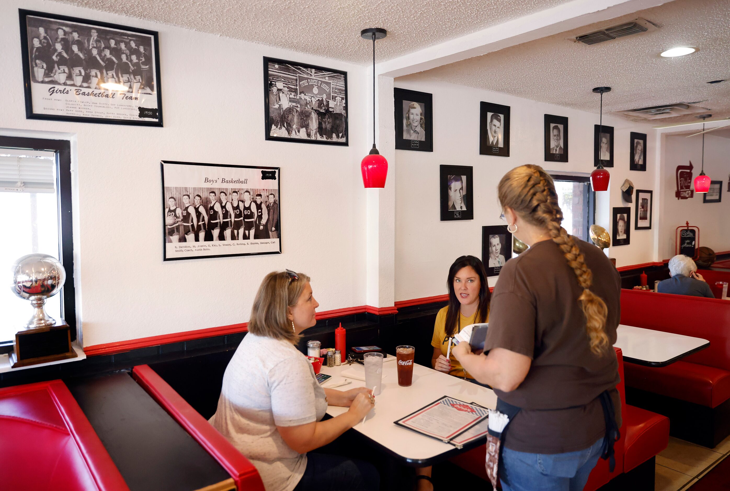 Waitress Rita Eggleston takes an order from lunchtime diners at Hot Rodz Diner in downtown...