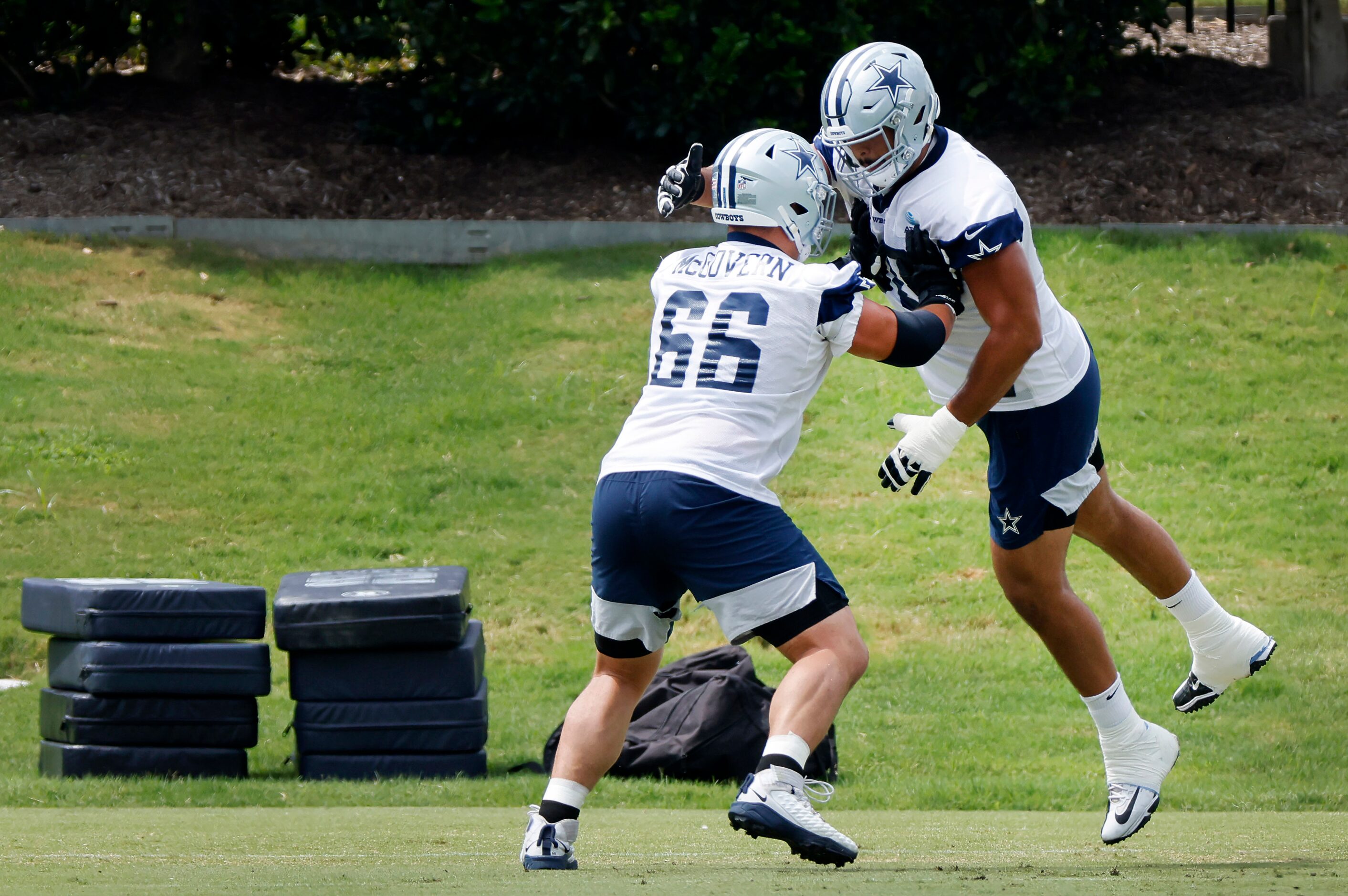 Dallas Cowboys guard Connor McGovern (66) pushes on offensive tackle Isaac Alarcon (60)...