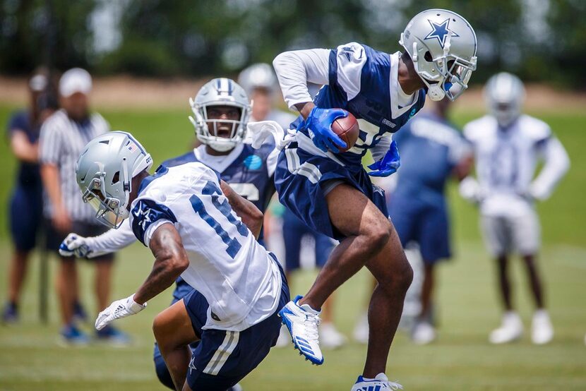 Cowboys cornerback Jourdan Lewis (27) intercepts a pass intended for wide receiver Cedrick...