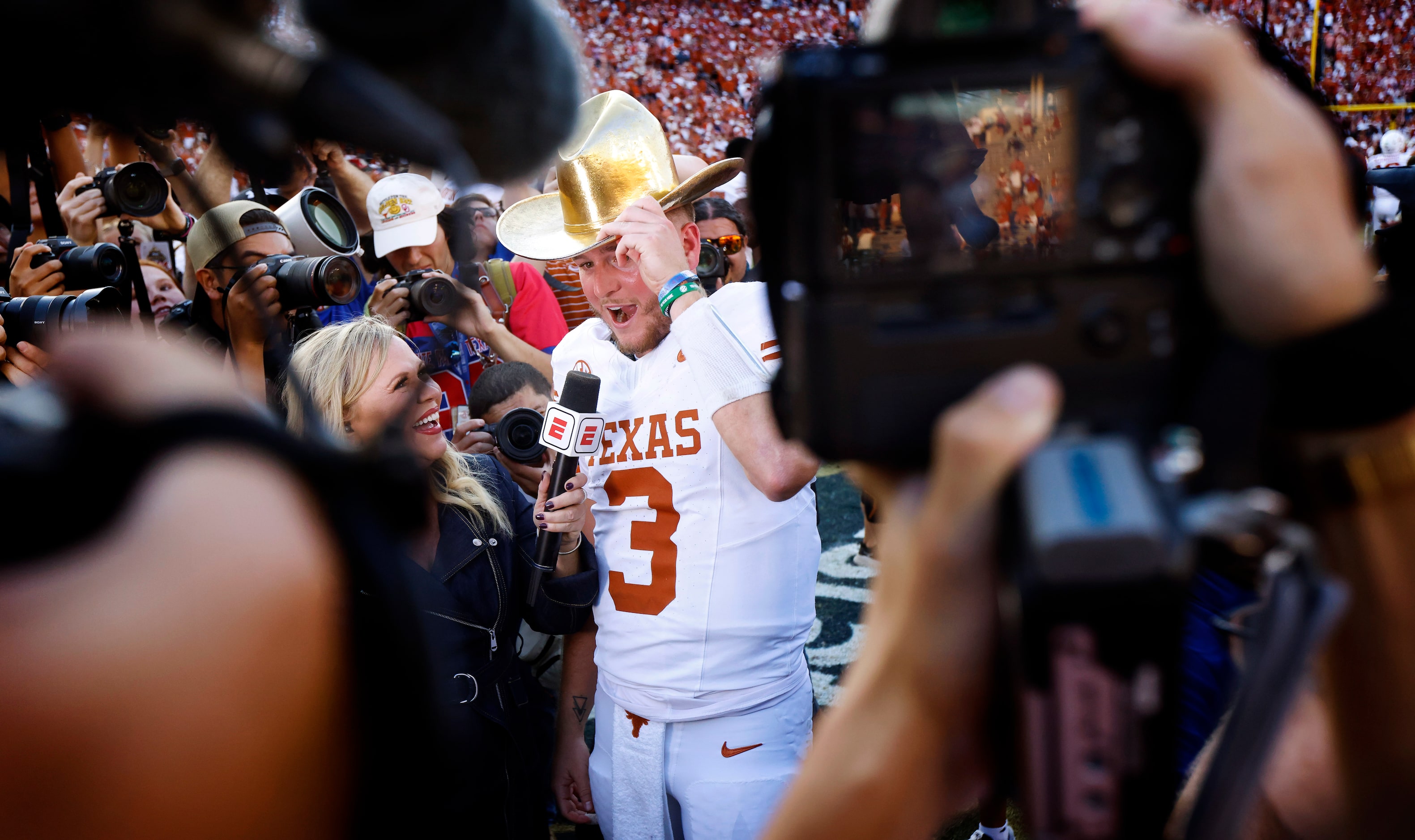 Texas Longhorns quarterback Quinn Ewers (3) dons the winning Golden Hat trophy as he’s...