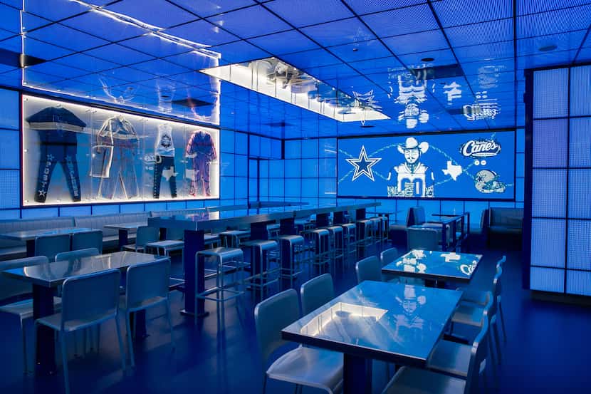 The new Post Malone and Dallas Cowboys themed Raising Cane's restaurant is washed in Cowboys...