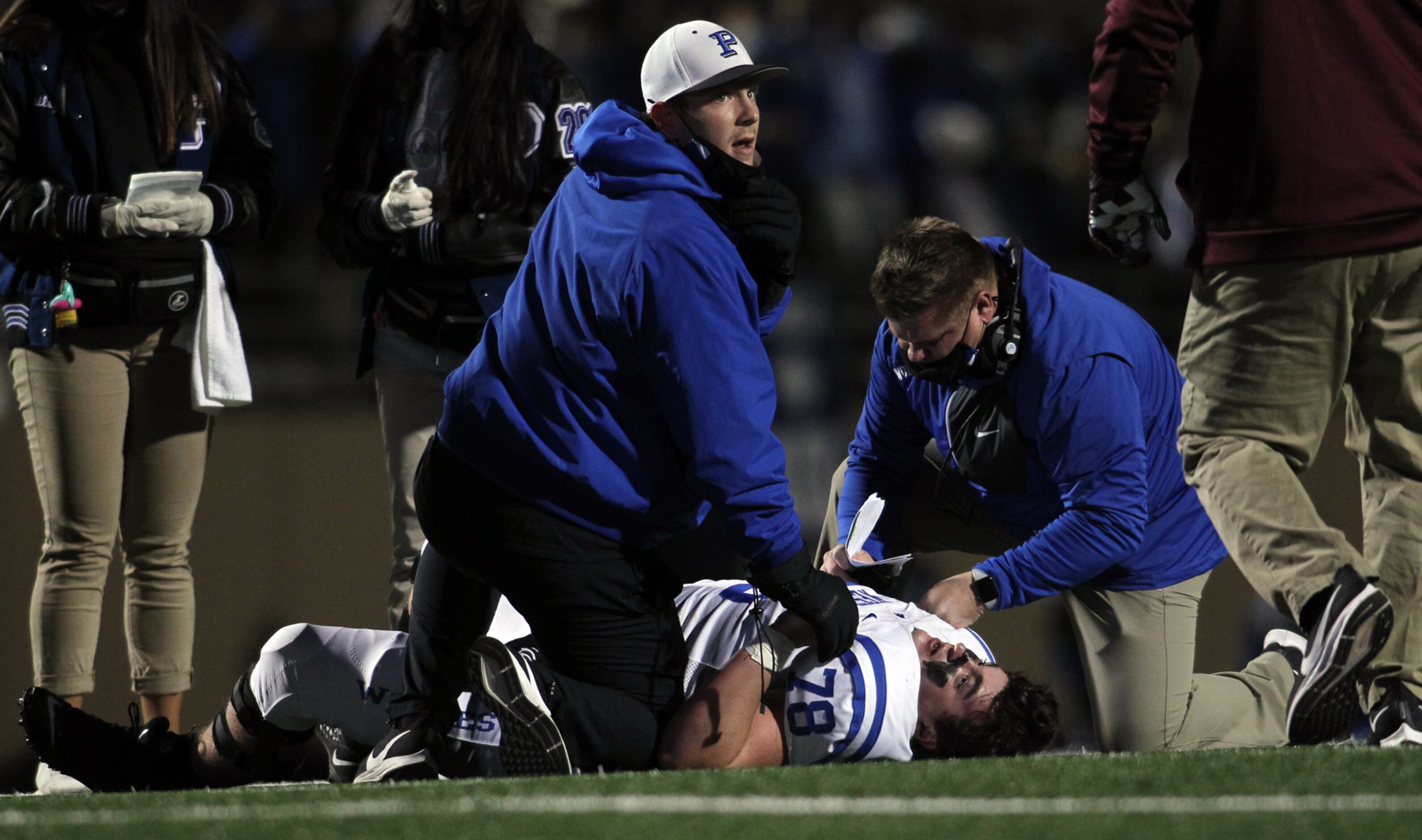Plano and Plano West trainers and coachers are quick to aid Plano West offensive lineman...