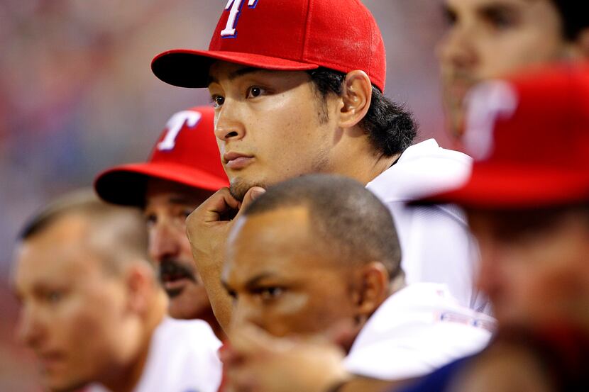 Texas Rangers starting pitcher Yu Darvish (11) watches his teammates at the plate after...