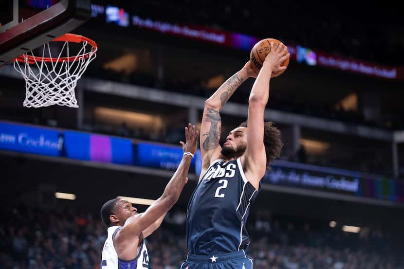Dallas Mavericks center Dereck Lively II (2) puts in a basket over Sacramento Kings guard...