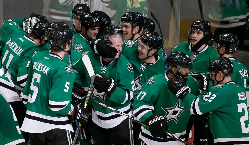 Dallas Stars players including Esa Lindell (23), who scored the game-winning goal against...