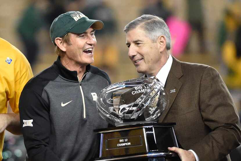 Baylor Bears head coach Art Briles accepts the Big XII trophy from Big XII commissioner Bob...