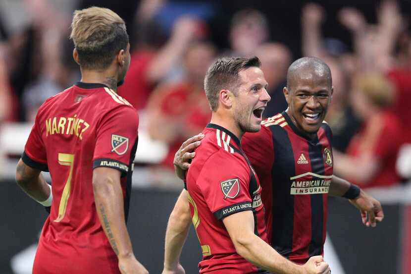 Atlanta United midfielder Kevin Kratz, center, celebrates scoring his second goal of the...
