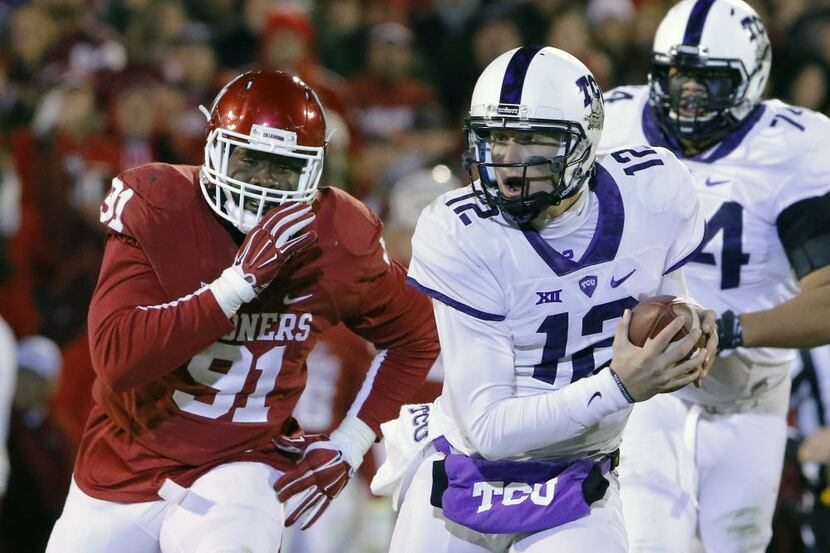 TCU quarterback Foster Sawyer (12) is chased down by Oklahoma defensive end Charles Tapper...