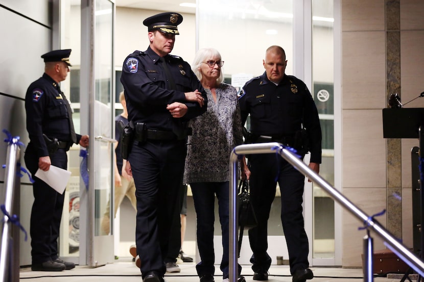 Mesquite Assistant Police Chief Doug Yates (left) escorts Debra Myers, mother of fallen...