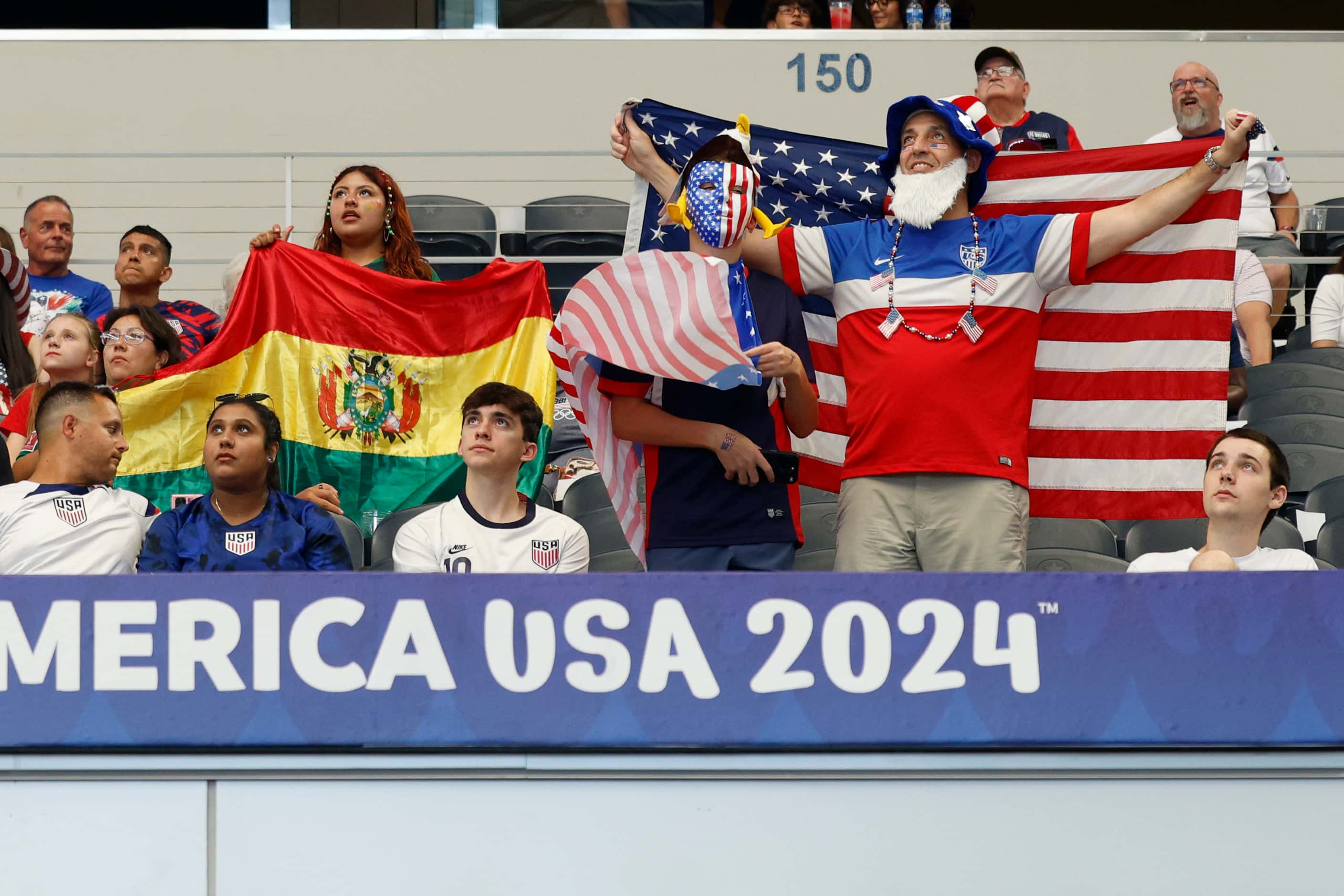 Bolivia and United States soccer fans stand and wave their flags before a Copa America Group...