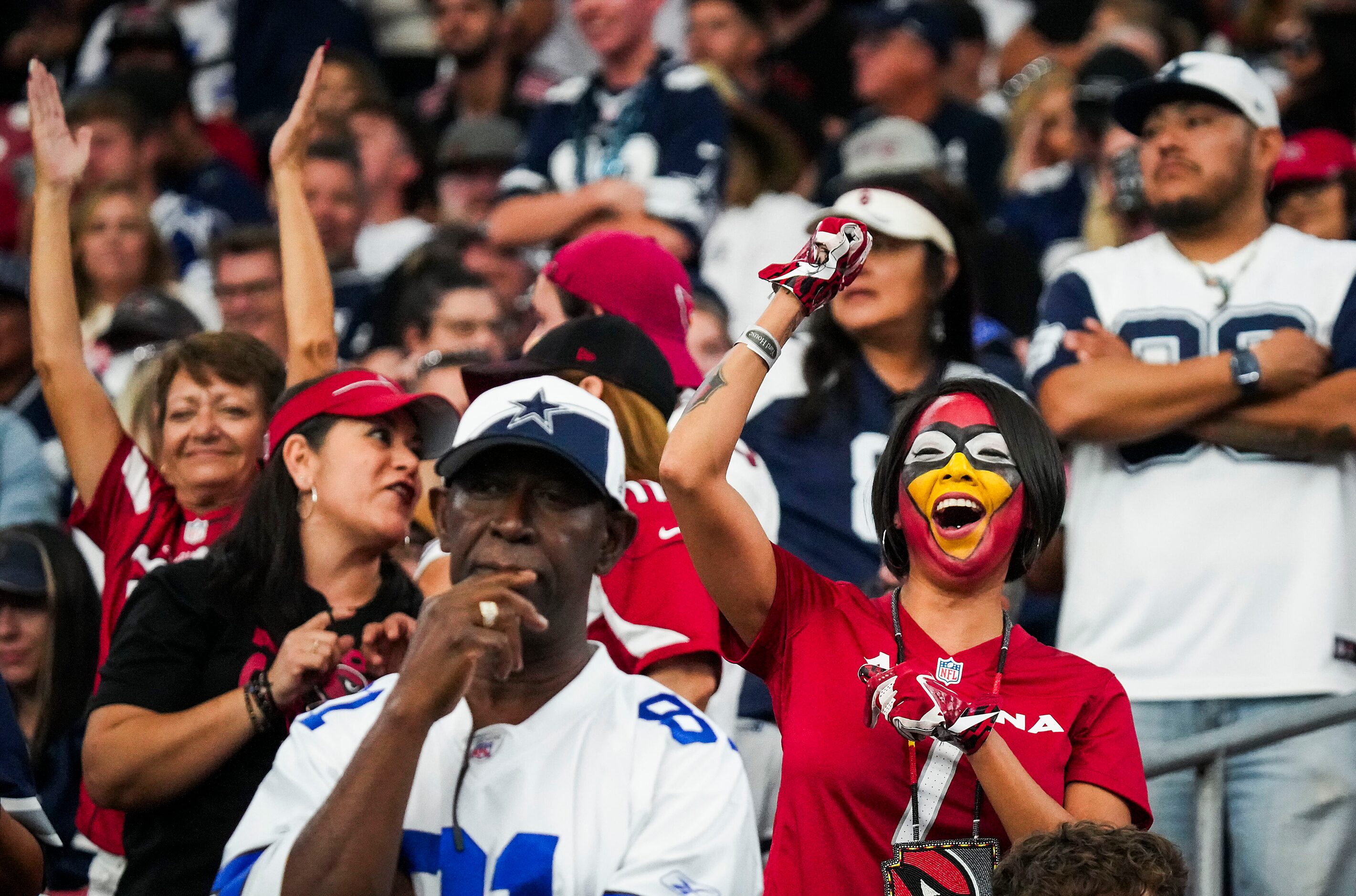 Arizona Cardinals fans cheer in the final minutes of a victory over the Dallas Cowboys in an...