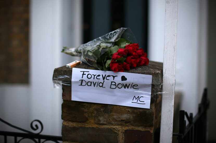 LONDON, ENGLAND - JANUARY 11:  A message is left with flowers outside the boyhood home of...