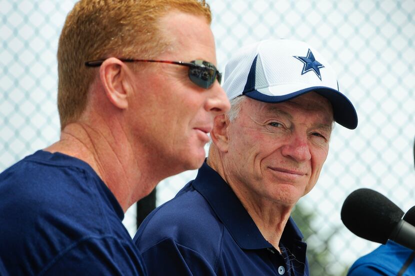 Dallas Cowboys owner Jerry Jones, right, watches as head coach Jason Garrett, left, answers...