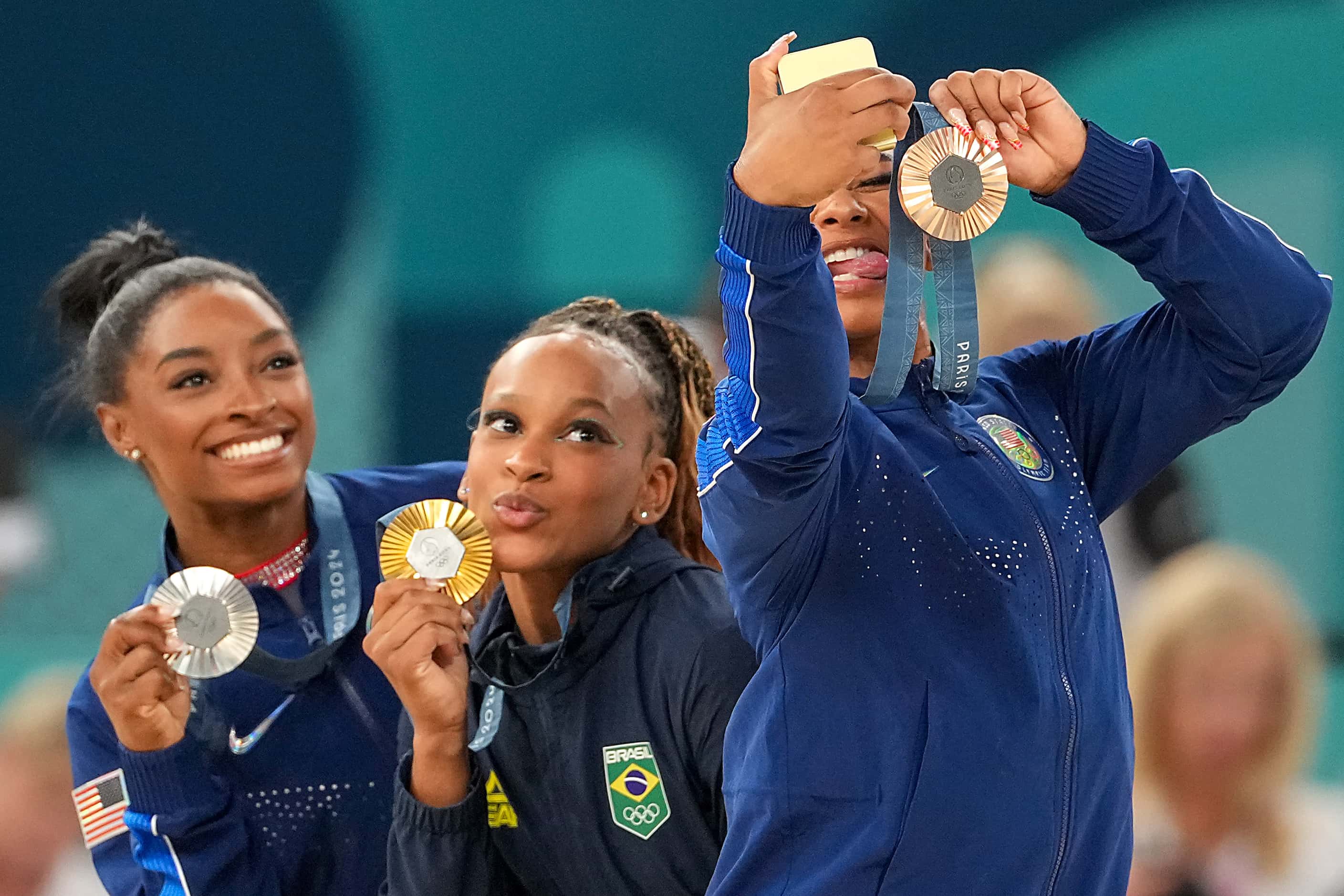 Bonze medalist Jordan Chiles of the United States takes a selfie with gold medalist Rebeca...