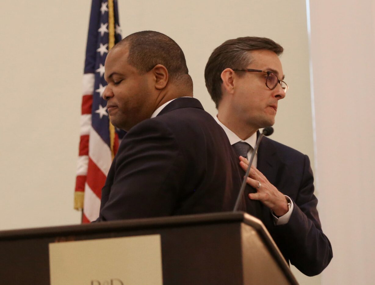 Candidates Eric Johnson (left) and Scott Griggs greet each other before the Dallas mayoral...