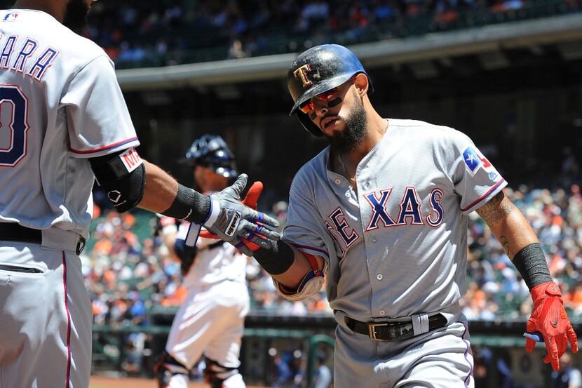 Texas Rangers' Rougned Odor, right, celebrates his solo home run against the Houston Astros...