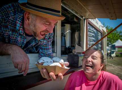 Summer Ladd gets a face full of powdered sugar from trio of beignets served up by proprietor...