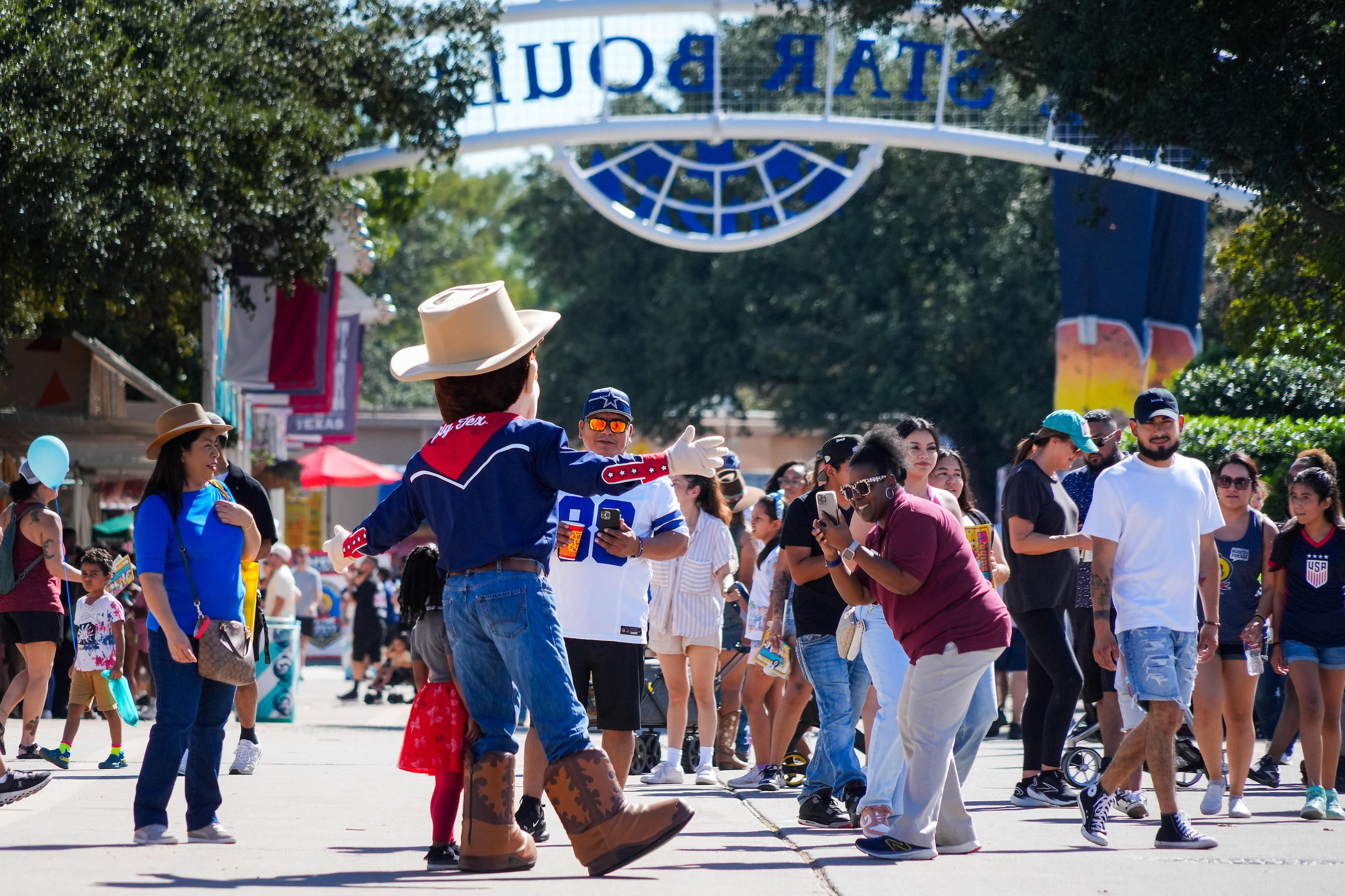 Little Big Tex poses with fairgoers on Lone Star Boulevard at the State Fair of Texas on...