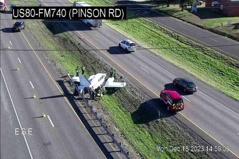 A screenshot of a TxDOT camera shows a small aircraft in the median of U.S. 80 in Forney on...