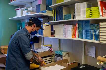 Will Evans, executive director of Deep Vellum Publishing, packages online orders for at Deep...