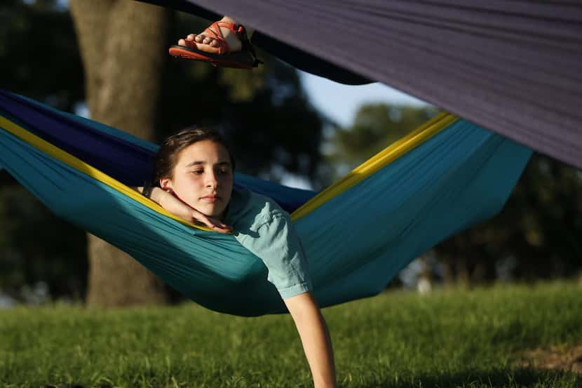 Emerson Palazzo, 13, lies in her ENO hammock with friends at Phillips Creek Ranch in Frisco,...