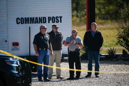 Investigators work a crime scene Sunday after a shooting at The Party Venue on Highway 380...