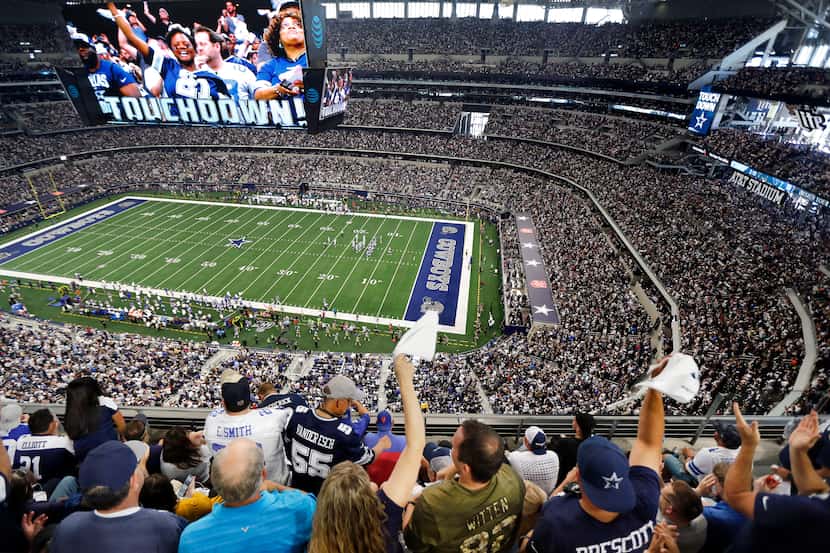 FILE - Fans are displayed on the giant overhead video screen as Cowboys fans cheer tight end...
