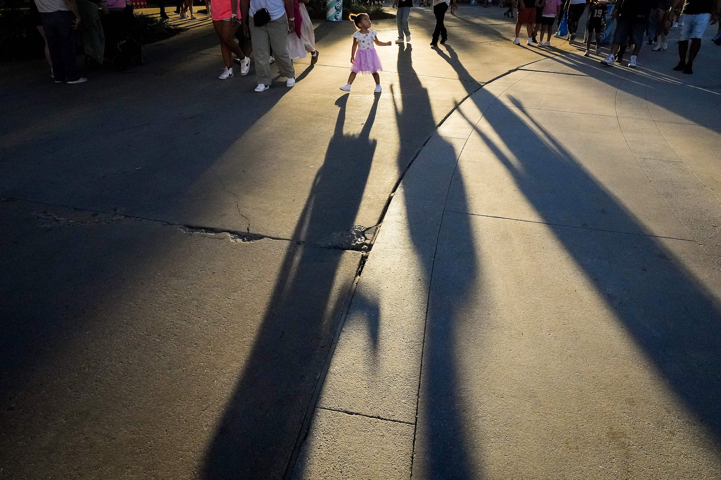 A youngster casts a long shadow while looking up at Big Tex at the State Fair of Texas on...