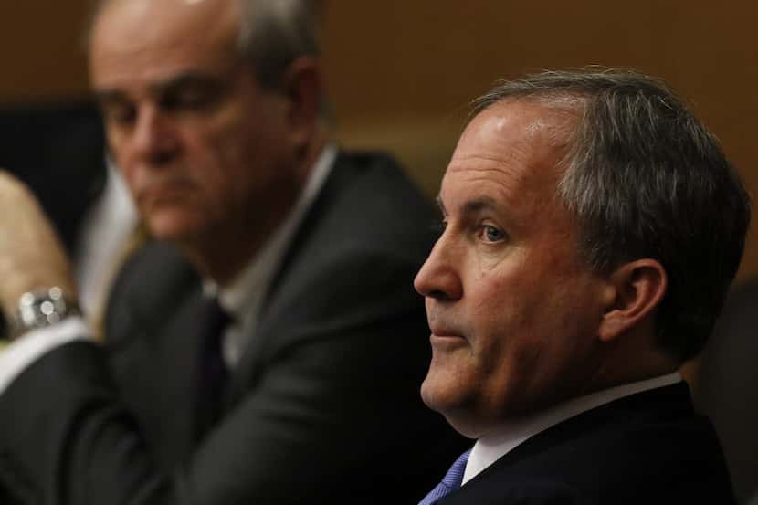  Texas Attorney General Ken Paxton, right, is shown at a hearing in December at the Collin...