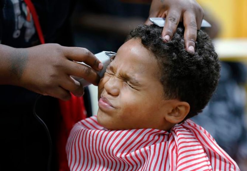 
Tyshawn Jensen, 8, grimaced as Terra Jackson got close with the shears but the spiffy...