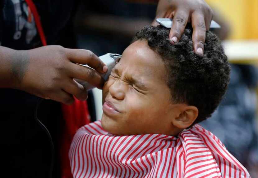 
Tyshawn Jensen, 8, grimaced as Terra Jackson got close with the shears but the spiffy...