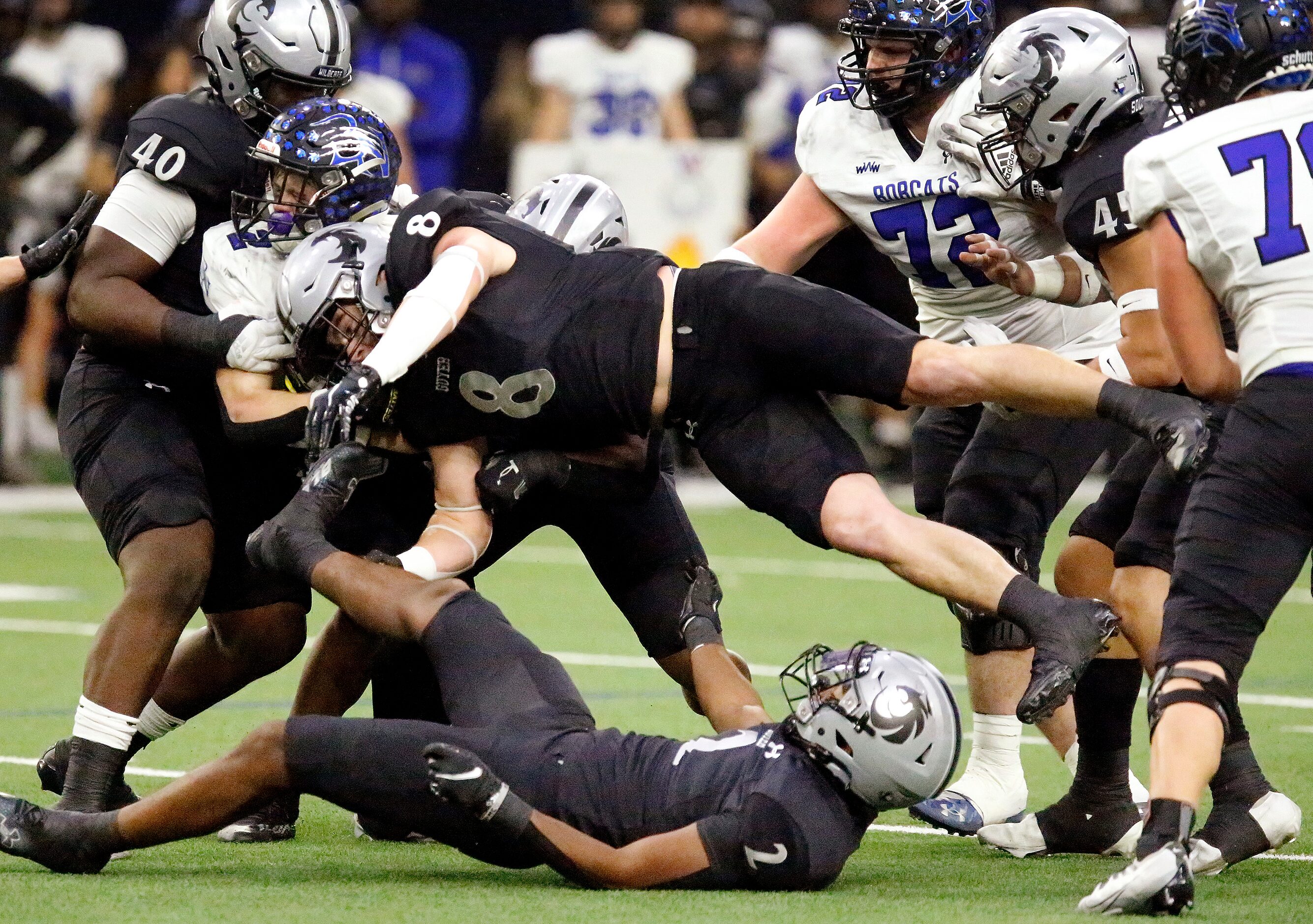 Guyer High School linebacker Blade Carver (8) launches into Byron Nelson High School running...