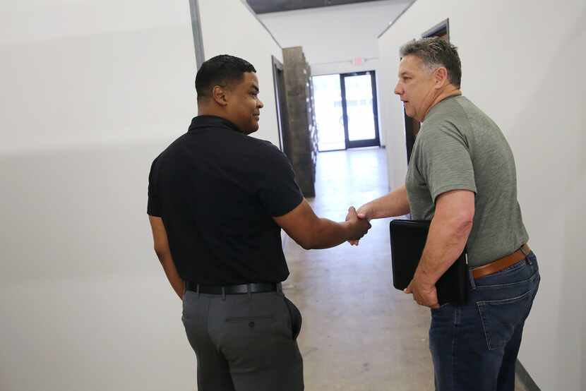 Yodchai Roseborough (left), an insurance specialist with Insurament, shakes hands with Monte...