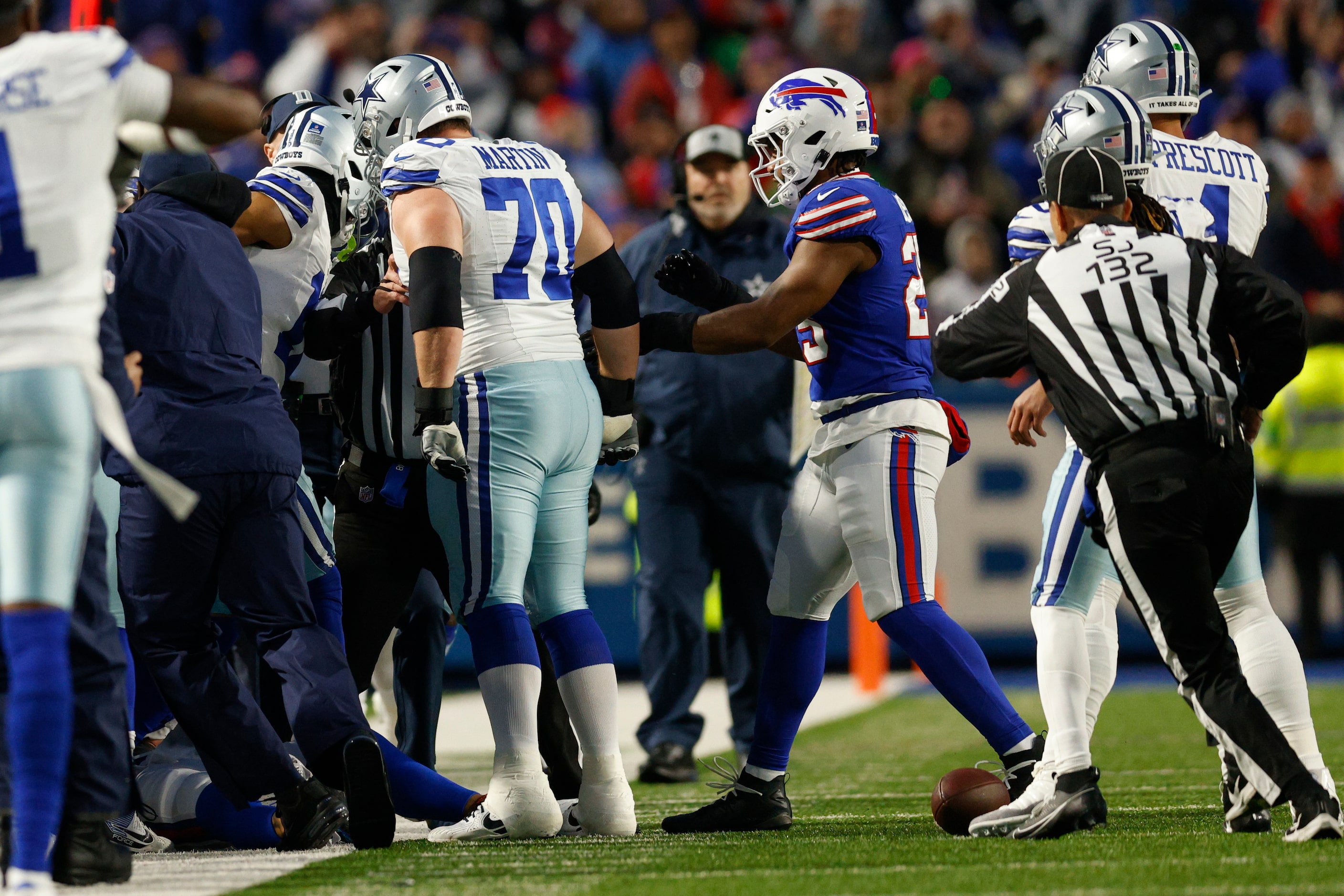 Dallas Cowboys guard Zack Martin (70) stands over Buffalo Bills safety Taylor Rapp after he...