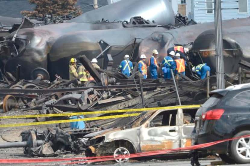 
Emergency workers examined the aftermath of a train derailment and fire in Lac-Mégantic,...