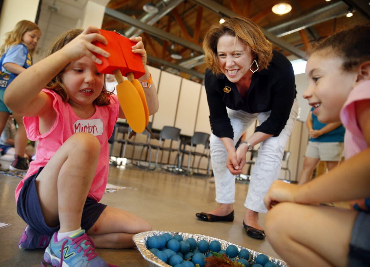 Girl Scouts of Northeast Texas CEO Jennifer Bartkowski (center) watches as Minton Lamm...