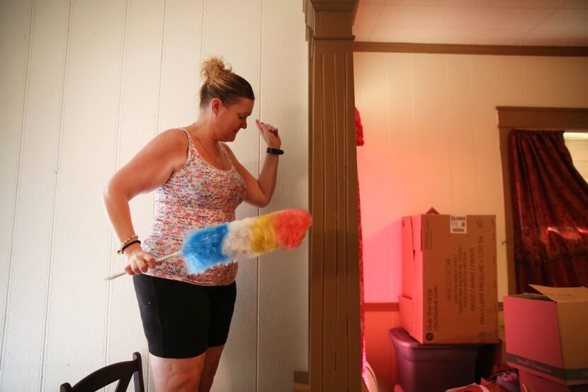 Margaret Davis, who has lost more than 100 pounds since last year, dances while cleaning her...