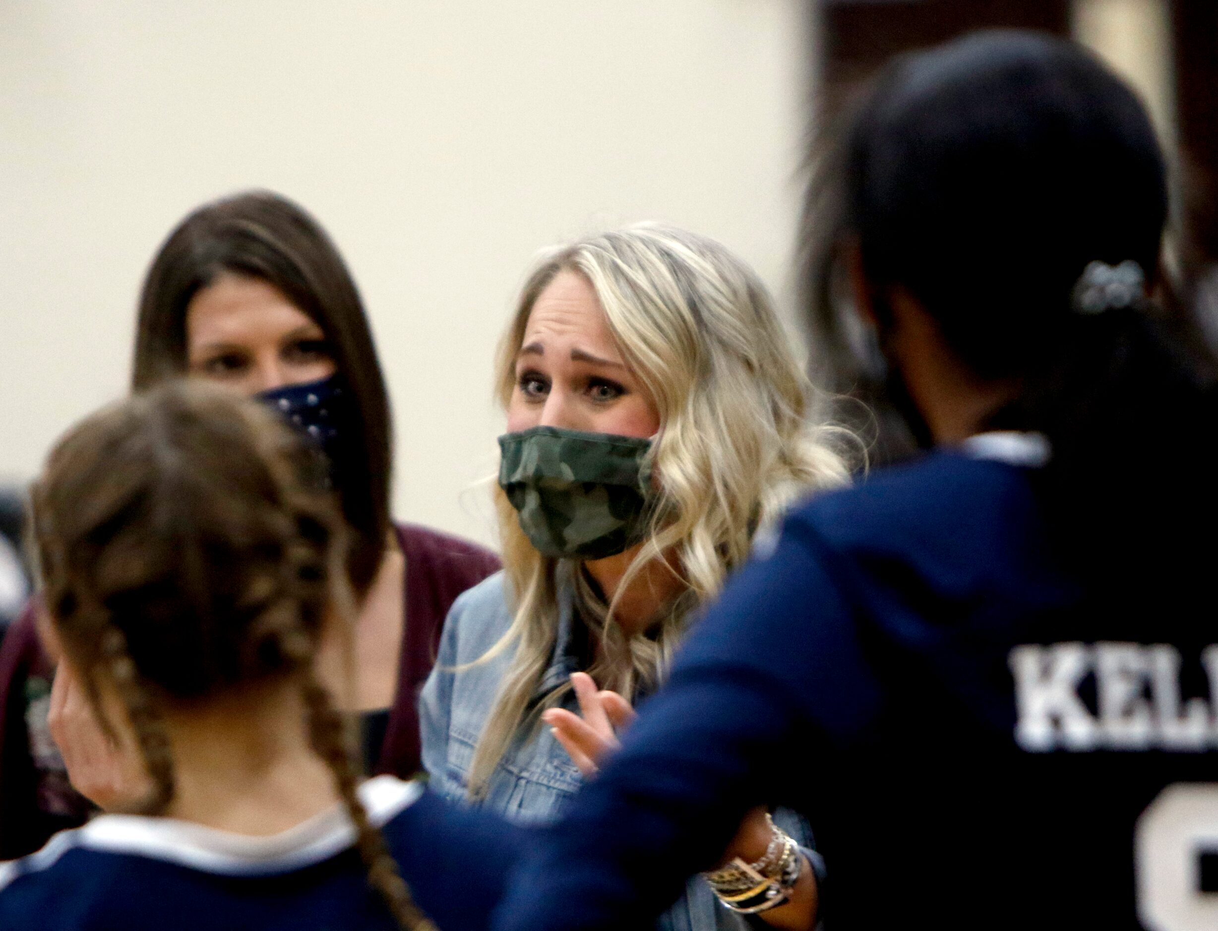 Keller head coach Lauren Rao speaks with members of her team during a timeout during the...