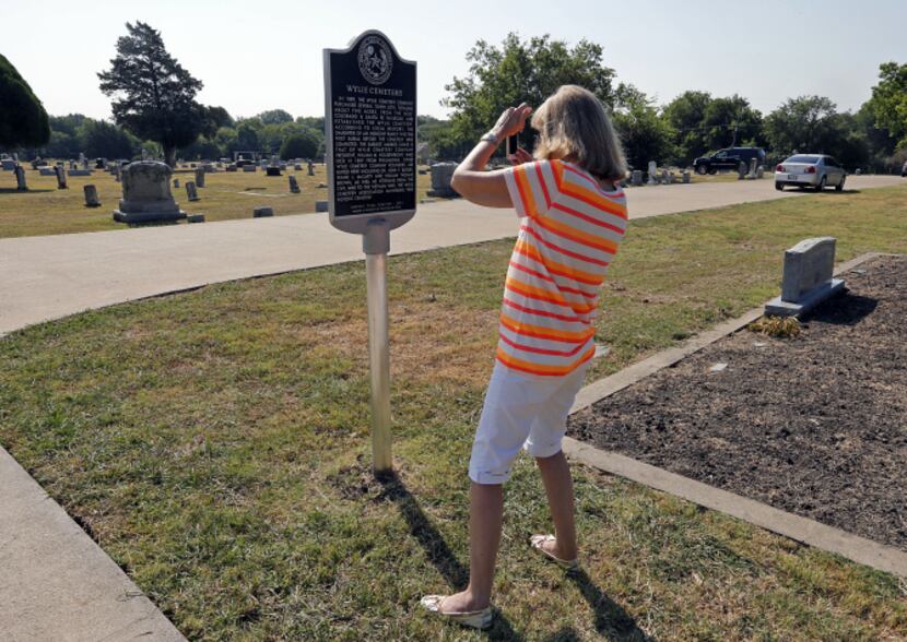 Barbara Ballard Turner of Plano takes a phone picture of a new Texas historical marker at...