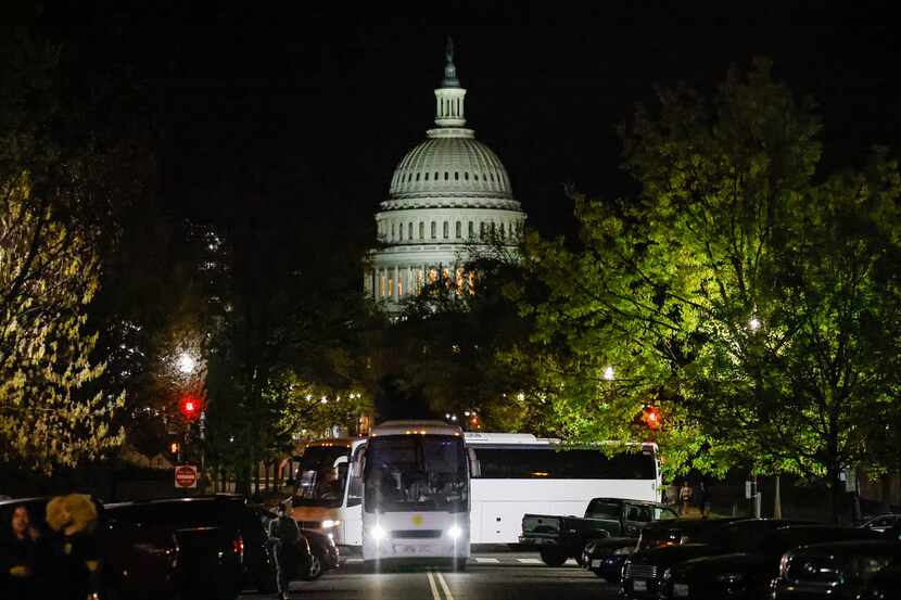 A couple of buses with migrants from Texas arrive in Washington, D.C. in April. The state...