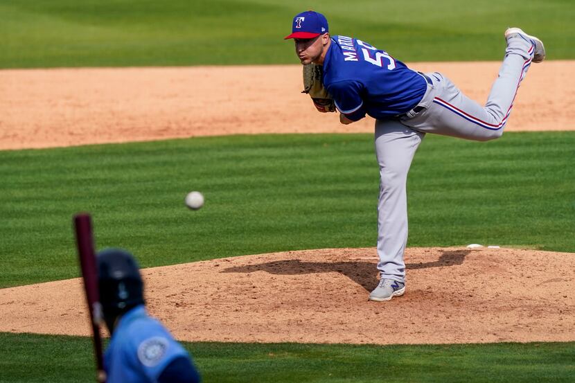 Texas Rangers pitcher Brett Martin pitches during the third inning of a spring training game...