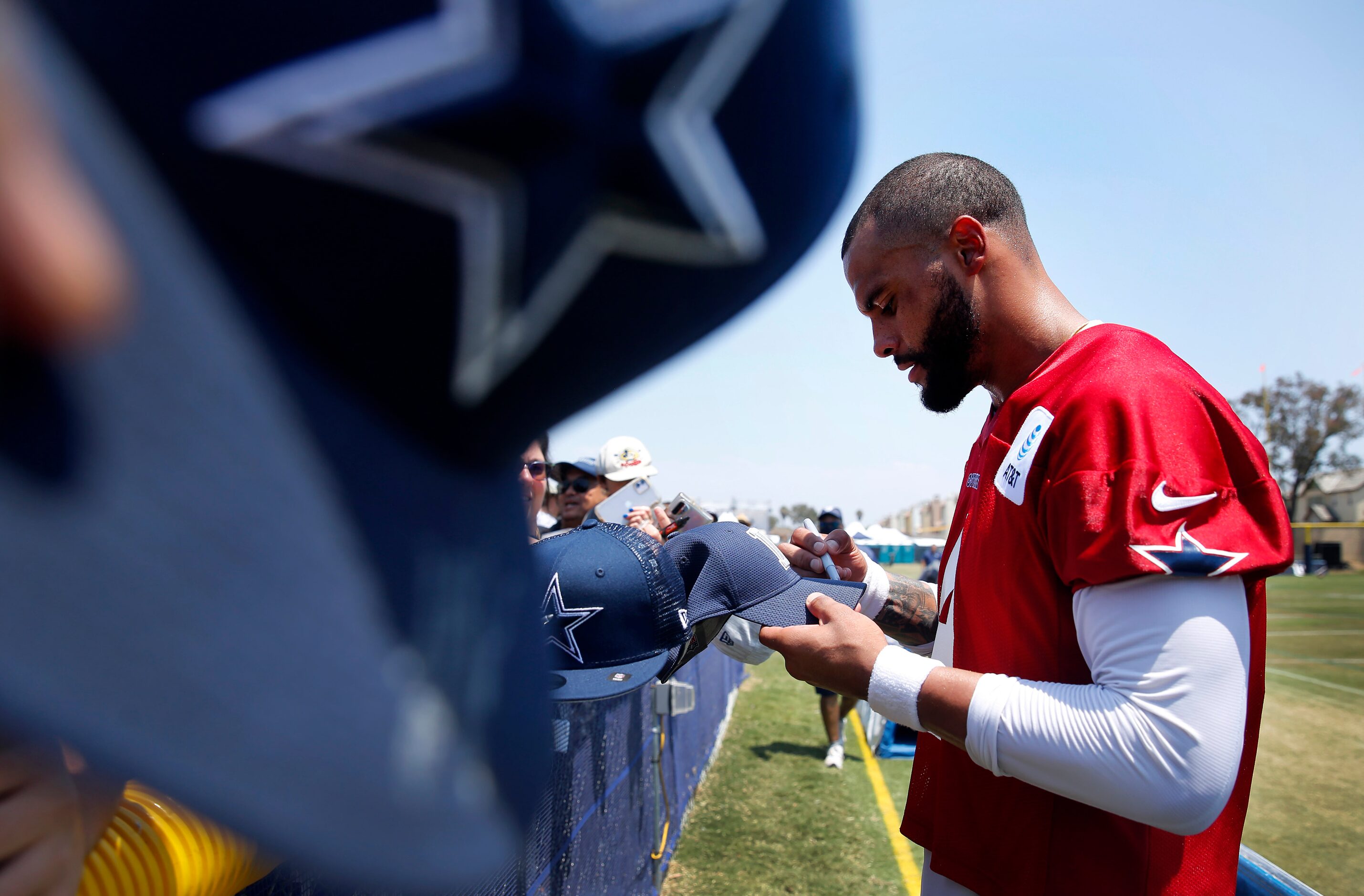 Dallas Cowboys quarterback Dak Prescott (4) signs autographs for fans following the second...