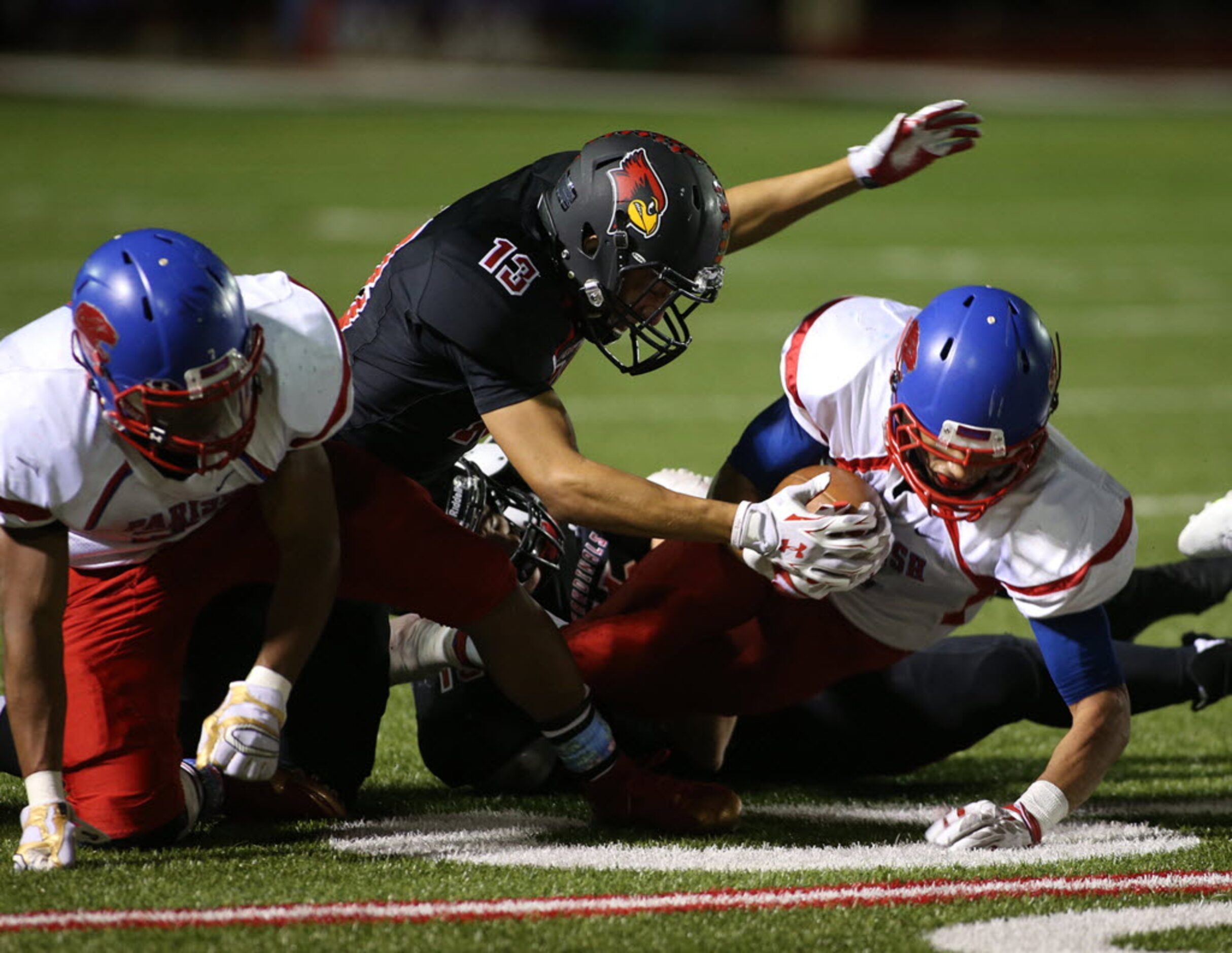 Parish Episcopal’s Kendel West (5) is tackled by Fort Worth Christian’s Greg Gomez (13)...