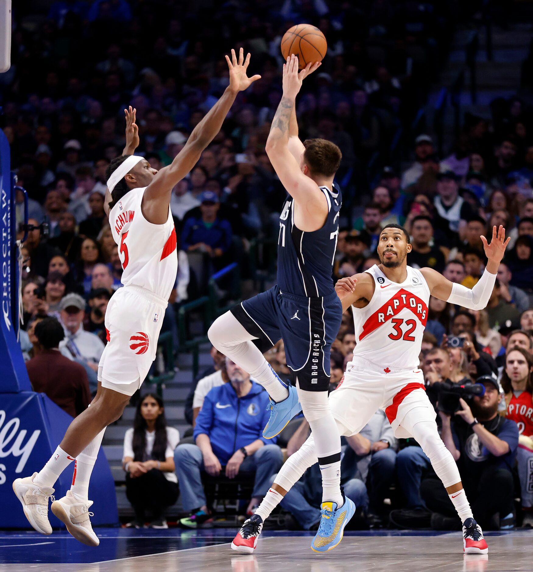 Dallas Mavericks guard Luka Doncic (77) puts up and makes a three-pointer over Toronto...