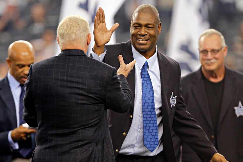 Charles Haley (right) high-fives Dallas Cowboys owner Jerry Joins as he joins the Ring of...
